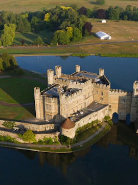 Leeds Castle with moat, Canterbury Cathedral, and Dover's White Cliffs on a London day trip.