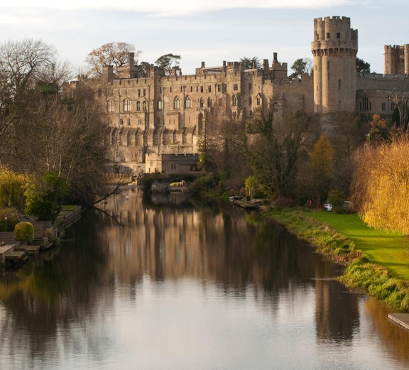 Warwick Castle with lush gardens, part of London to Warwick Tours.