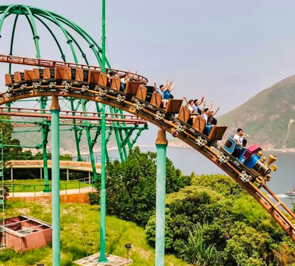 Ocean Park Hong Kong roller coaster with city skyline in background.