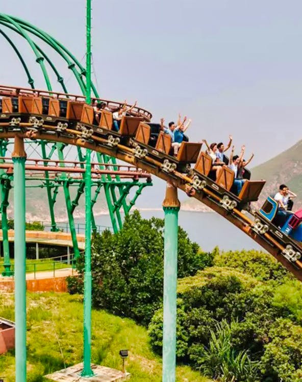 Ocean Park Hong Kong roller coaster with city skyline in background.