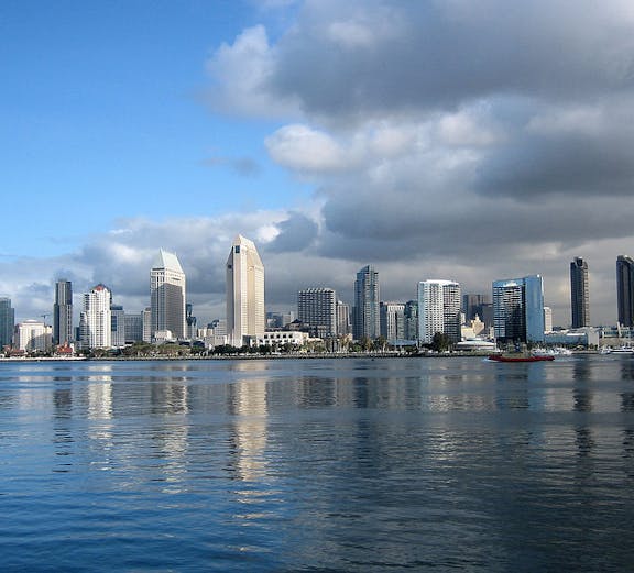 San Diego skyline with Coronado Bridge and waterfront attractions.