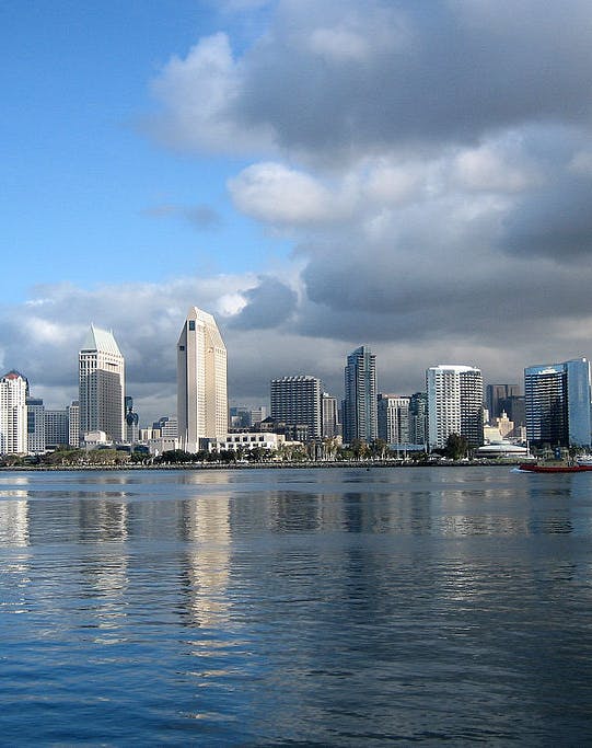 San Diego skyline with Coronado Bridge and waterfront attractions.