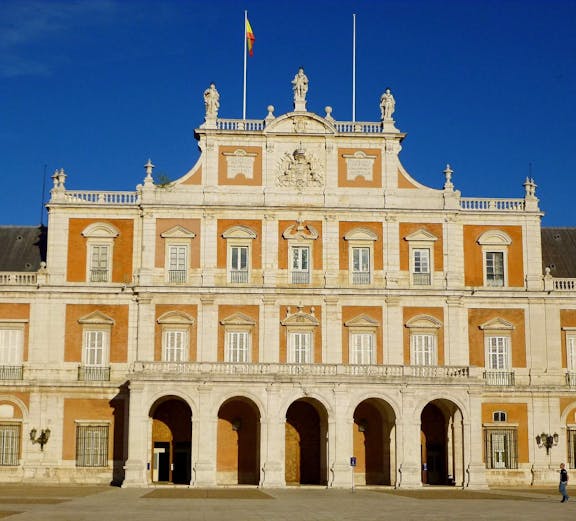 Royal Palace of Aranjuez in Madrid with ornate architecture and lush gardens.