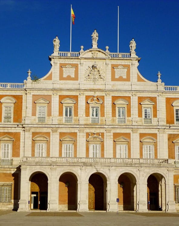 Royal Palace of Aranjuez in Madrid with ornate architecture and lush gardens.