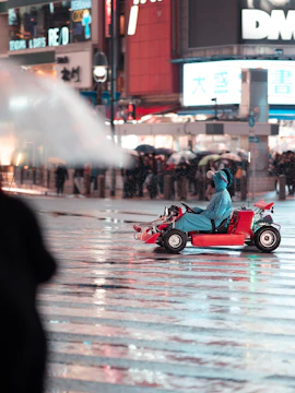 Tourists driving go-karts on Tokyo streets, experiencing real-life Mario Kart adventure.