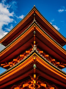 Kyoto's Kinkaku-ji Temple with golden pavilion reflecting in serene pond.