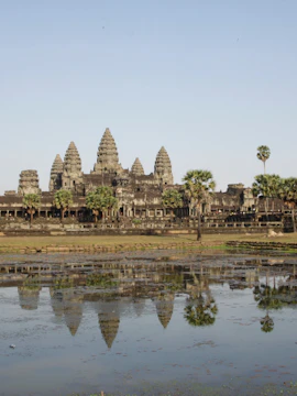 Angkor Wat temple complex in Siem Reap, Cambodia, with ancient stone architecture and surrounding greenery.