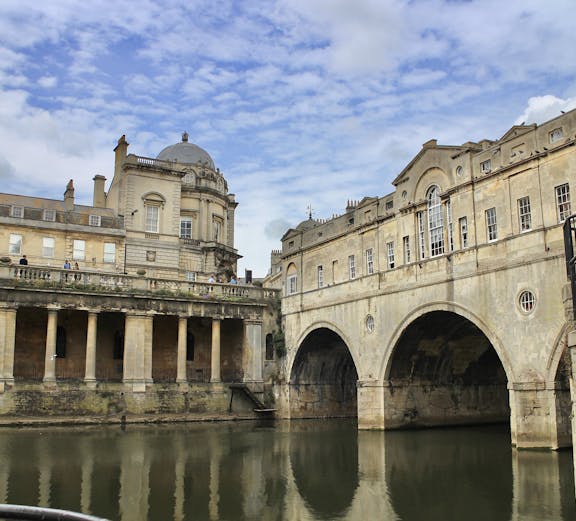London to Bath tour featuring the Roman Baths with visitors exploring the historic site.