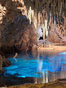 Okinawa beach kayaking tour with clear blue waters and lush green coastline.