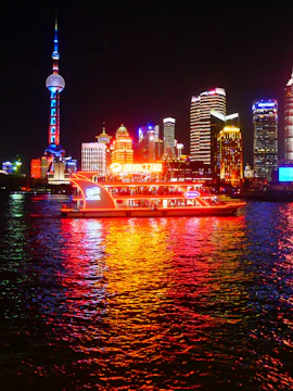 Huangpu River cruise with Shanghai skyline, including Oriental Pearl Tower.