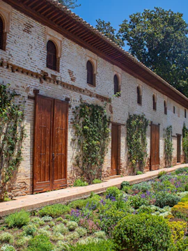 Generalife Gardens in Granada with lush greenery and historic architecture.