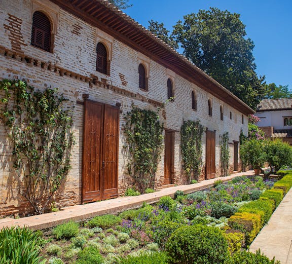 Generalife Gardens in Granada with lush greenery and historic architecture.
