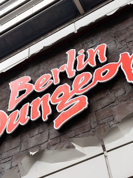Berlin Dungeon entrance with historical architecture and tourists gathered outside.