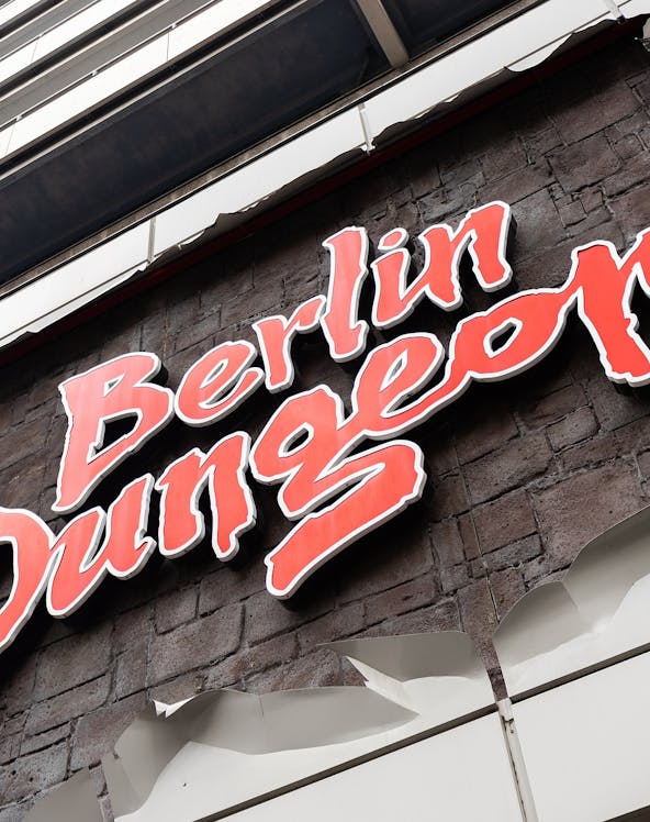 Berlin Dungeon entrance with historical architecture and tourists gathered outside.