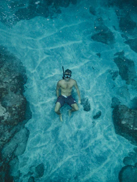Snorkelers exploring coral reefs in Okinawa, Japan.
