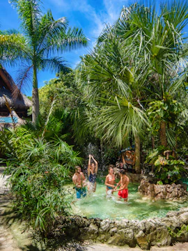 Xplor Park zip-lining adventure in Cancun, Mexico, showcasing lush jungle scenery.