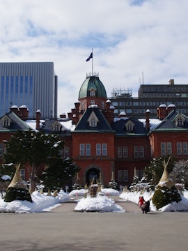 Hokkaido snow-covered landscape with traditional Japanese onsen.