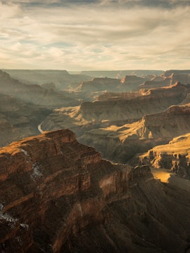 Grand Canyon view with layered rock formations under clear sky, tour from Las Vegas.
