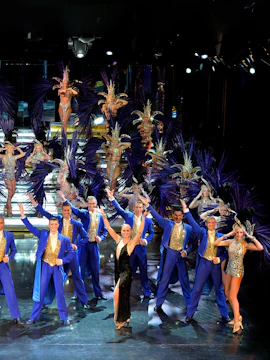 Cabaret performance at Le Lido in Paris, featuring dancers in elaborate costumes.
