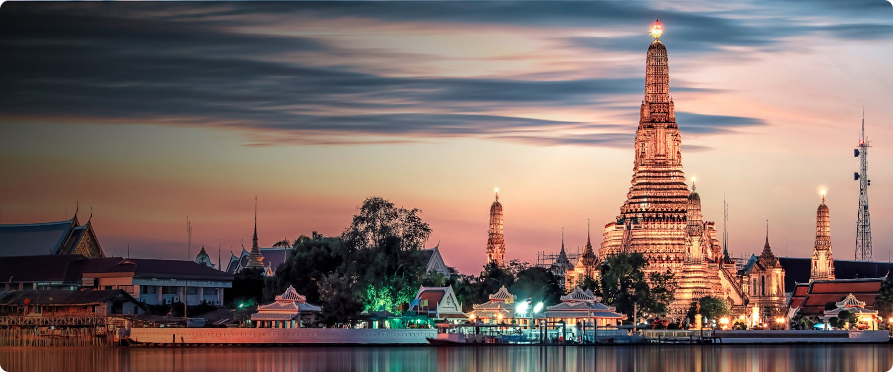 Wat Arun temple illuminated at sunset, Bangkok, Thailand.