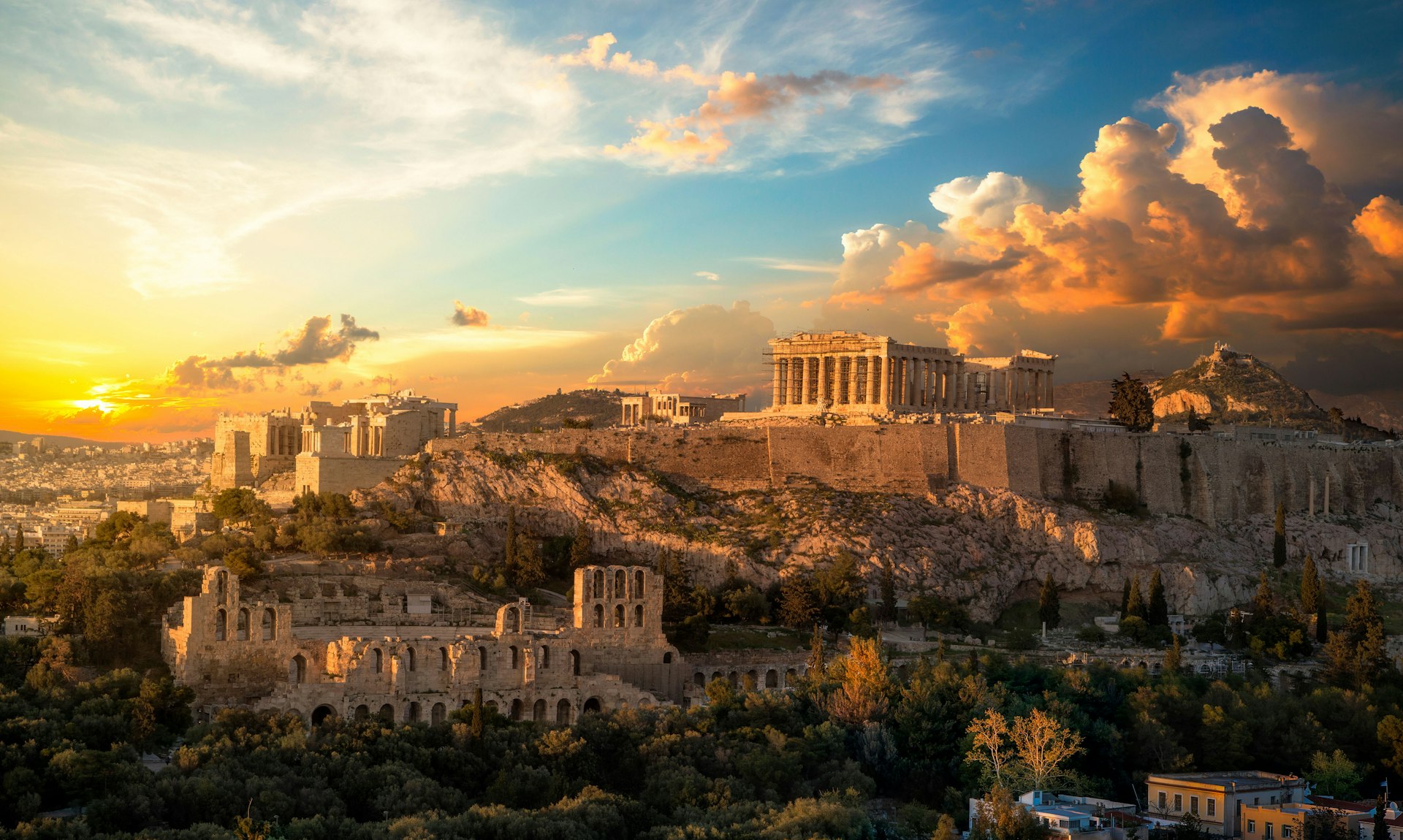 Parthenon temple on Acropolis hill in Athens, Greece, under clear July sky.