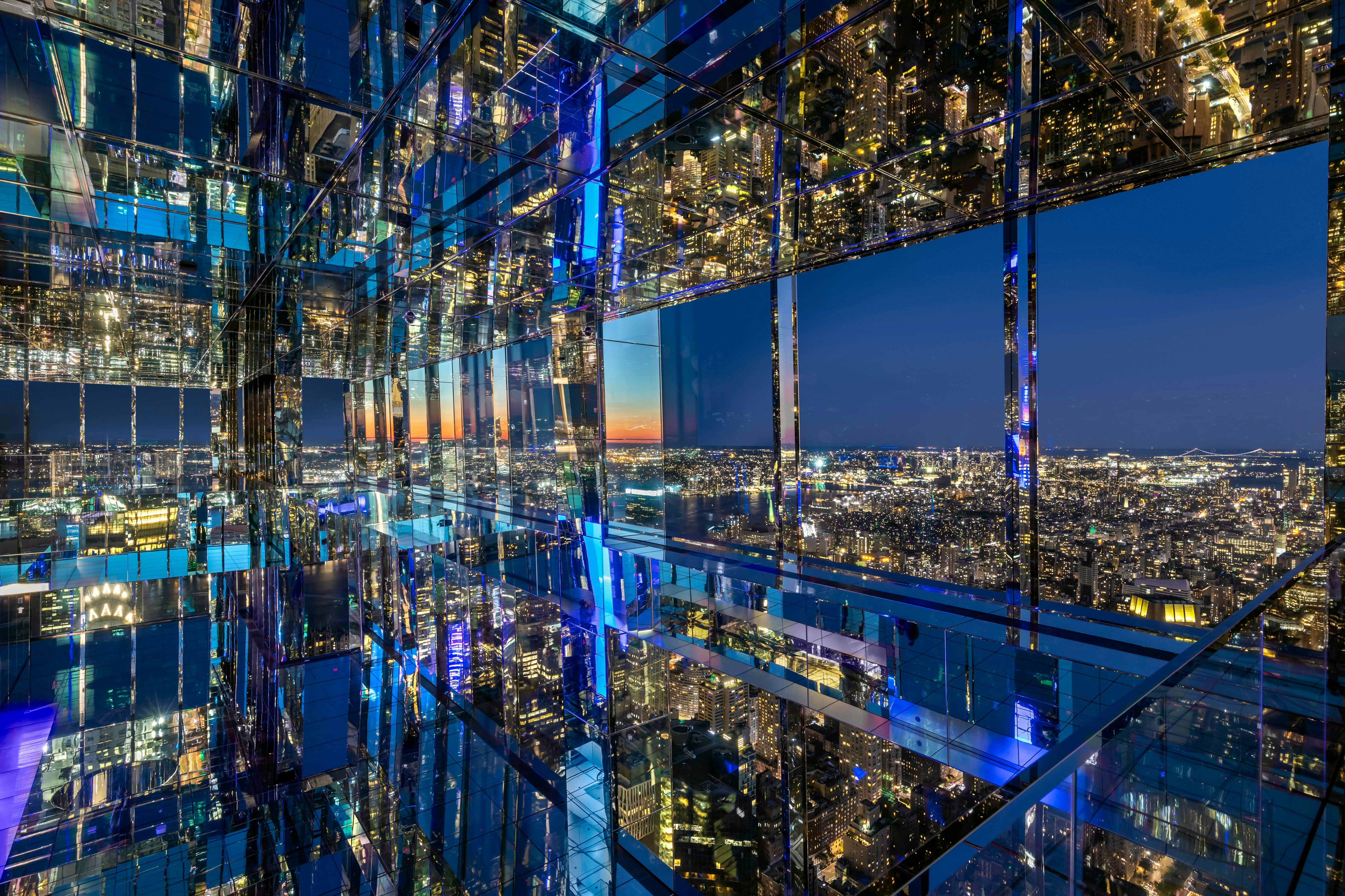 Summit One Vanderbilt observation deck view of New York City skyline at night.