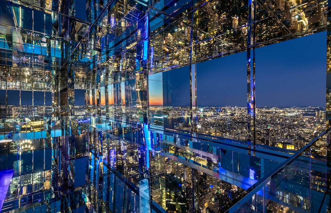 Summit One Vanderbilt observation deck view of New York City skyline at night.