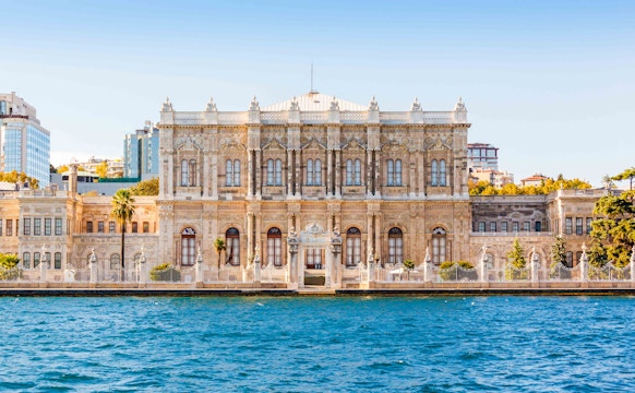 Dolmabahce Palace exterior with ornate architecture and Bosphorus view in Istanbul, Turkey.