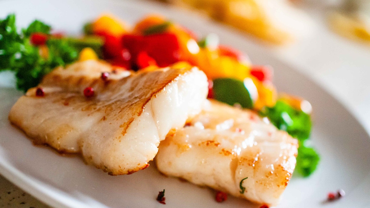 Grilled fish with vegetables served on a plate at a Palm Jumeirah restaurant.