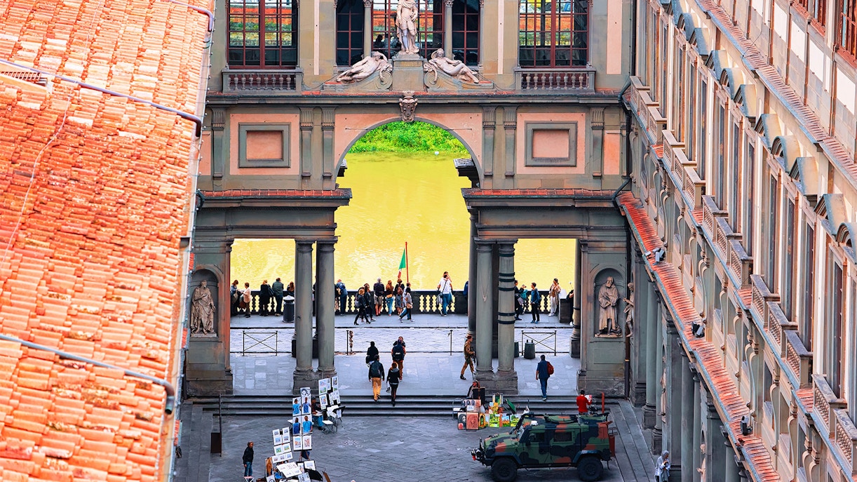 A bustling view from above of the Uffizi Gallery's entrance, where nearby shops add to the cultural tapestry, enticing art lovers and shoppers alike