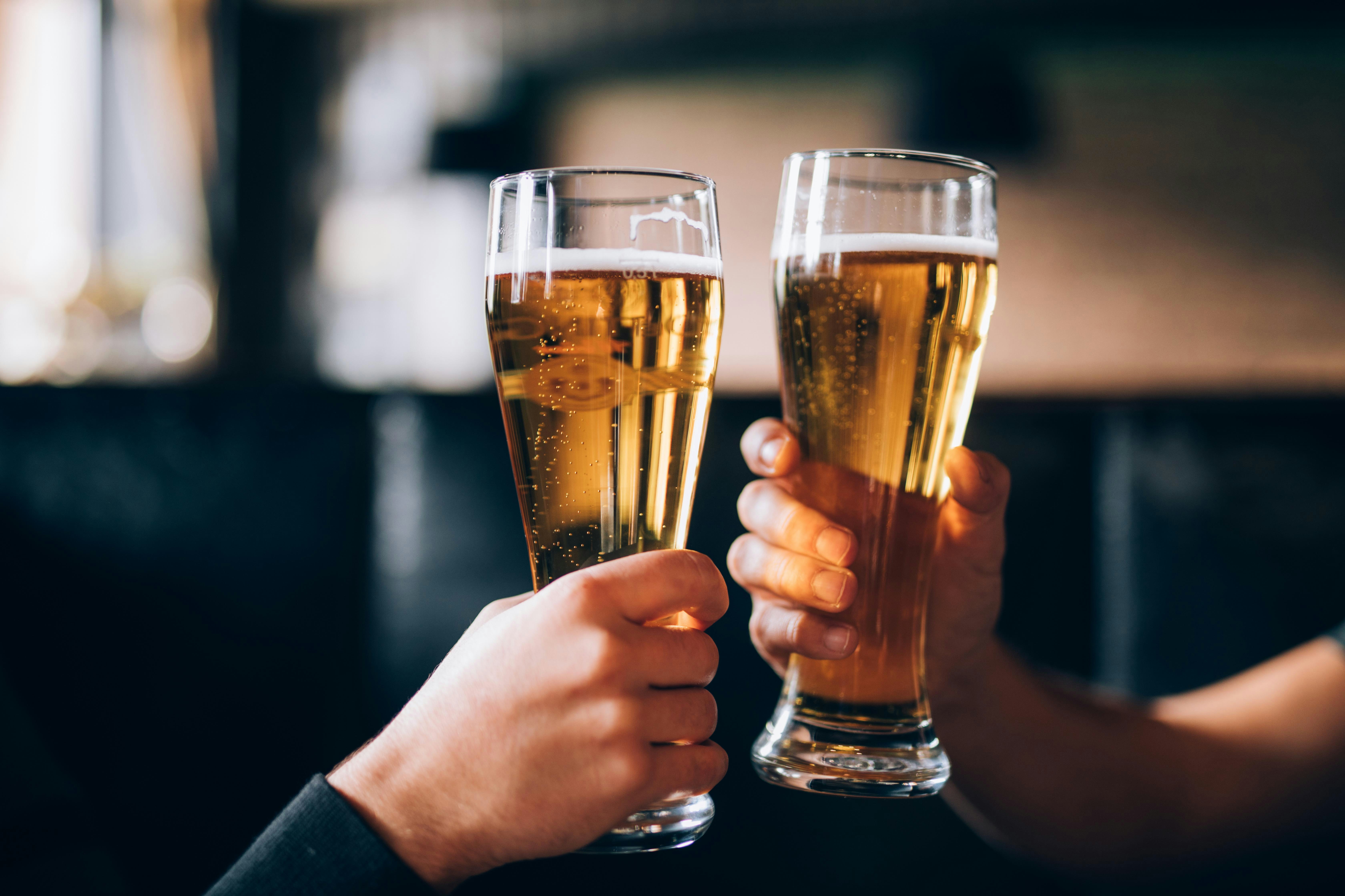 Two people toasting with beer glasses near Topkapi Palace, Istanbul.