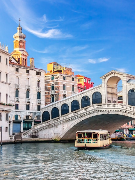 Boat passing under the Rialto Bridge on a Venice canal tour.