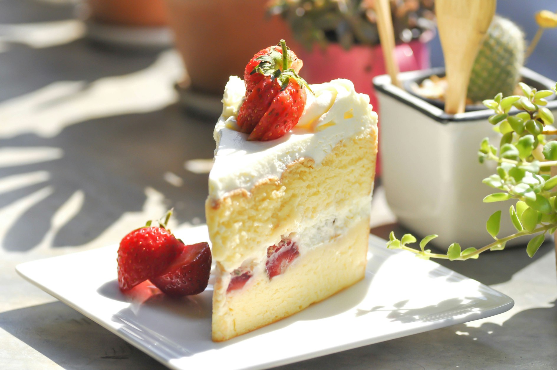 Strawberry shortcake dessert with fresh strawberries and whipped cream on a white plate.
