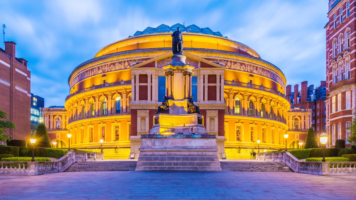 Royal Albert Hall illuminated at dusk, London Opera venue.