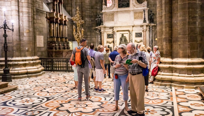 Duomo Milan Cathedral exterior with tourists in fast-track entry line
