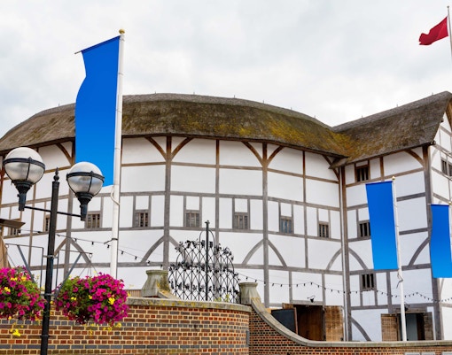 Shakespeare Globe Theatre exterior with tourists in London.