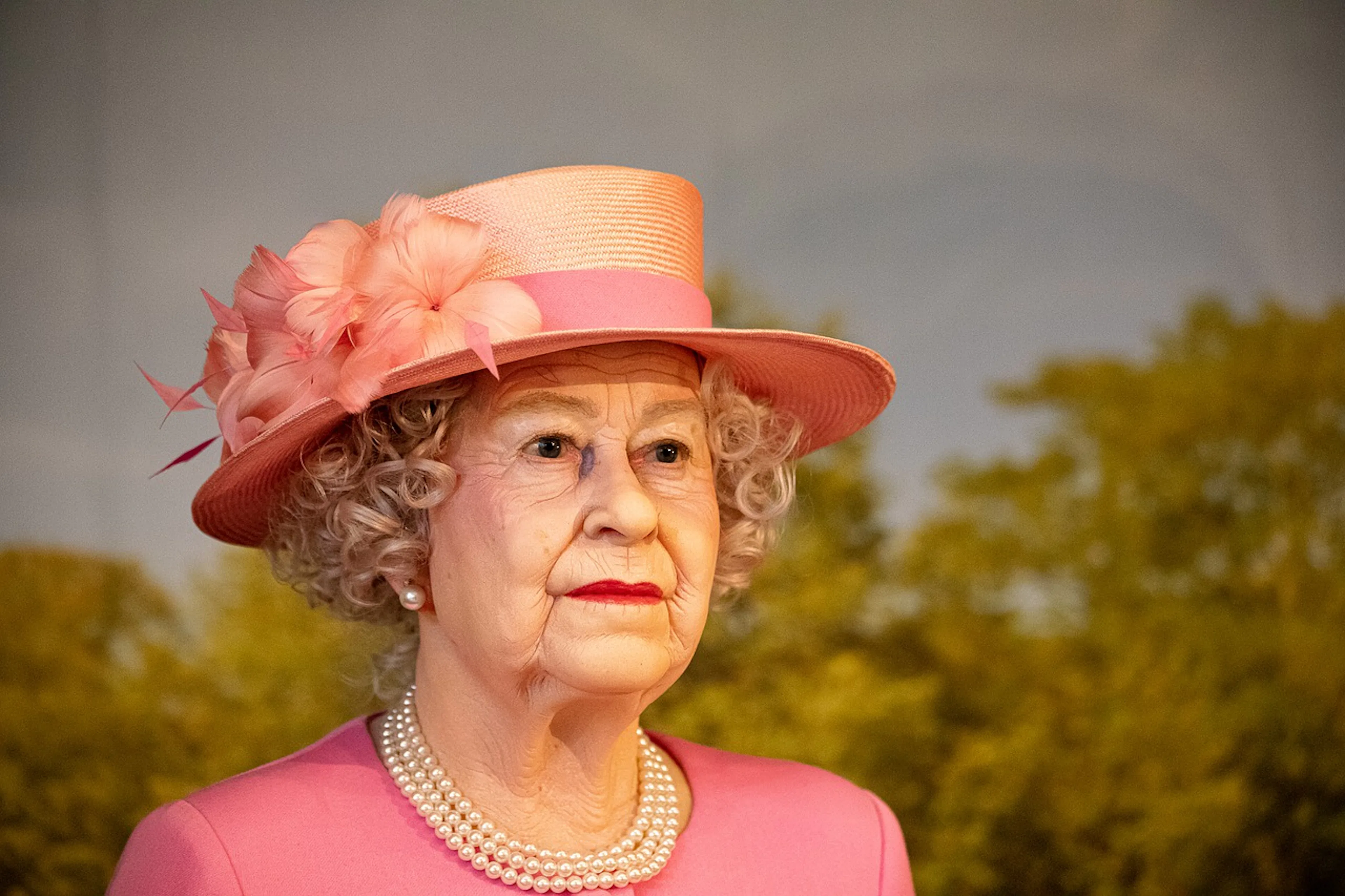Wax figure of a woman in a pink outfit and hat at Madame Tussauds Dubai.