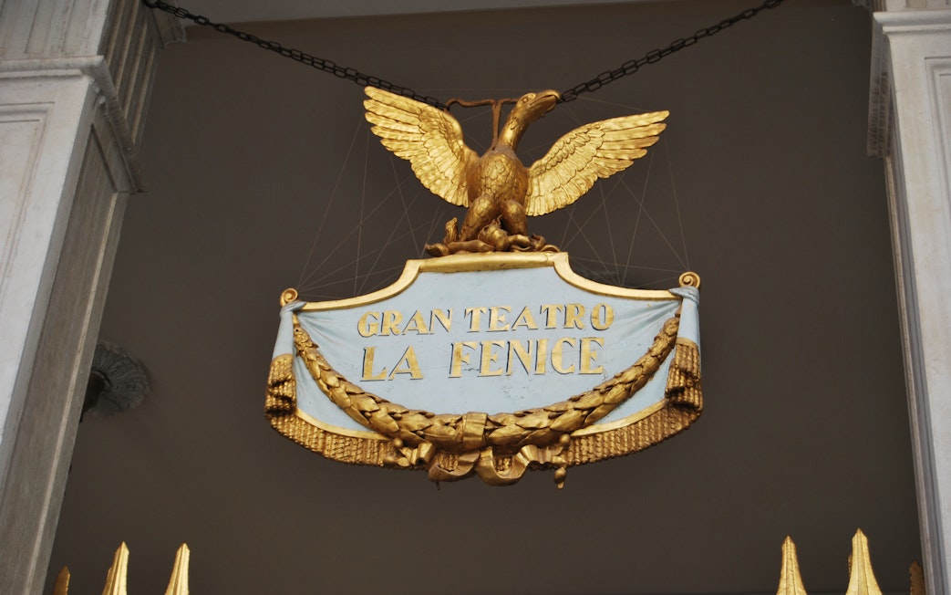 Gran Teatro La Fenice sign with golden eagle in Venice, Italy.