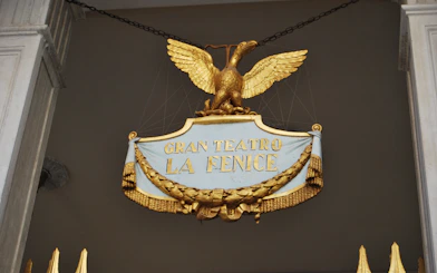 Gran Teatro La Fenice sign with golden eagle in Venice, Italy.