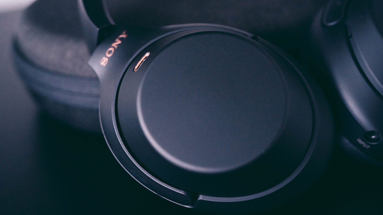 Noise cancelling headphones on a table, ideal for travel essentials.