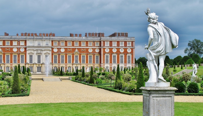 Visitors exploring the historical Hampton Court Palace, a unique day trip destination in London