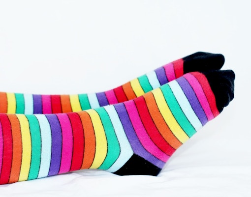 Colorful striped compression socks for travel essentials.