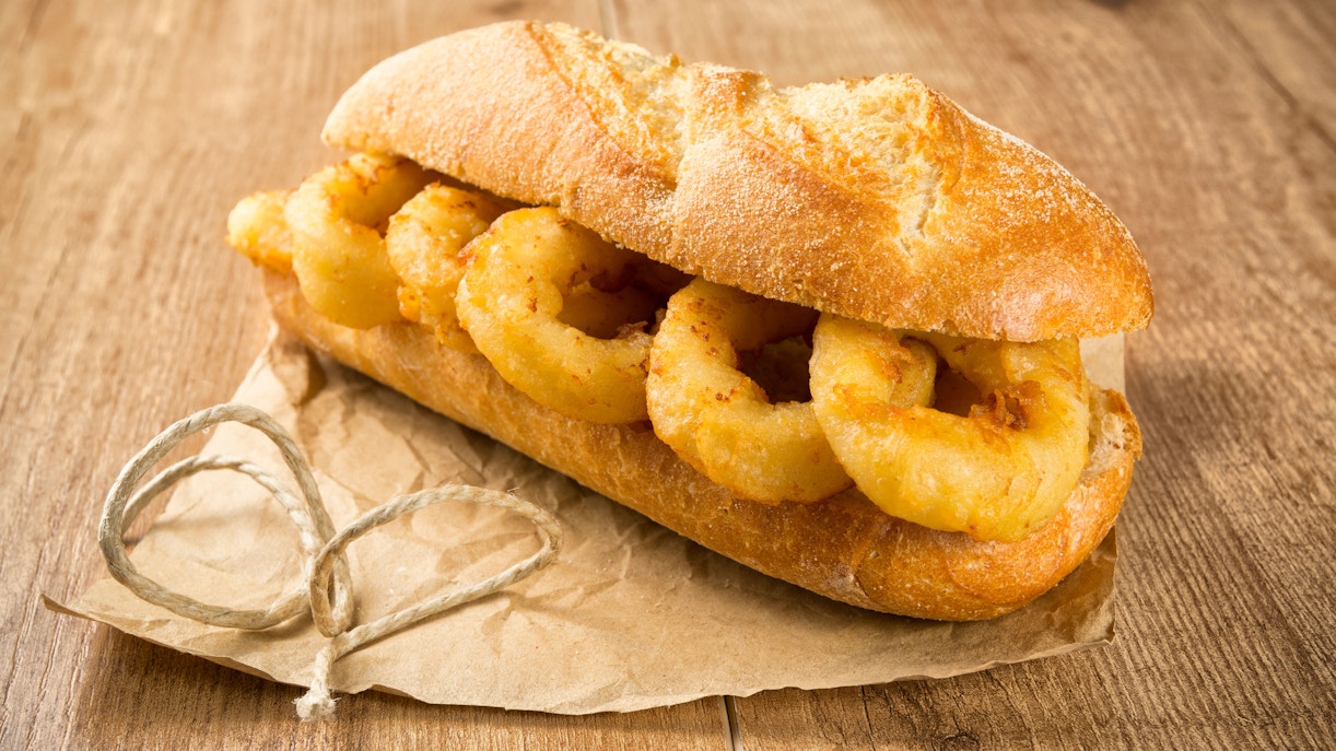 Calamari sandwich on rustic paper in Madrid.
