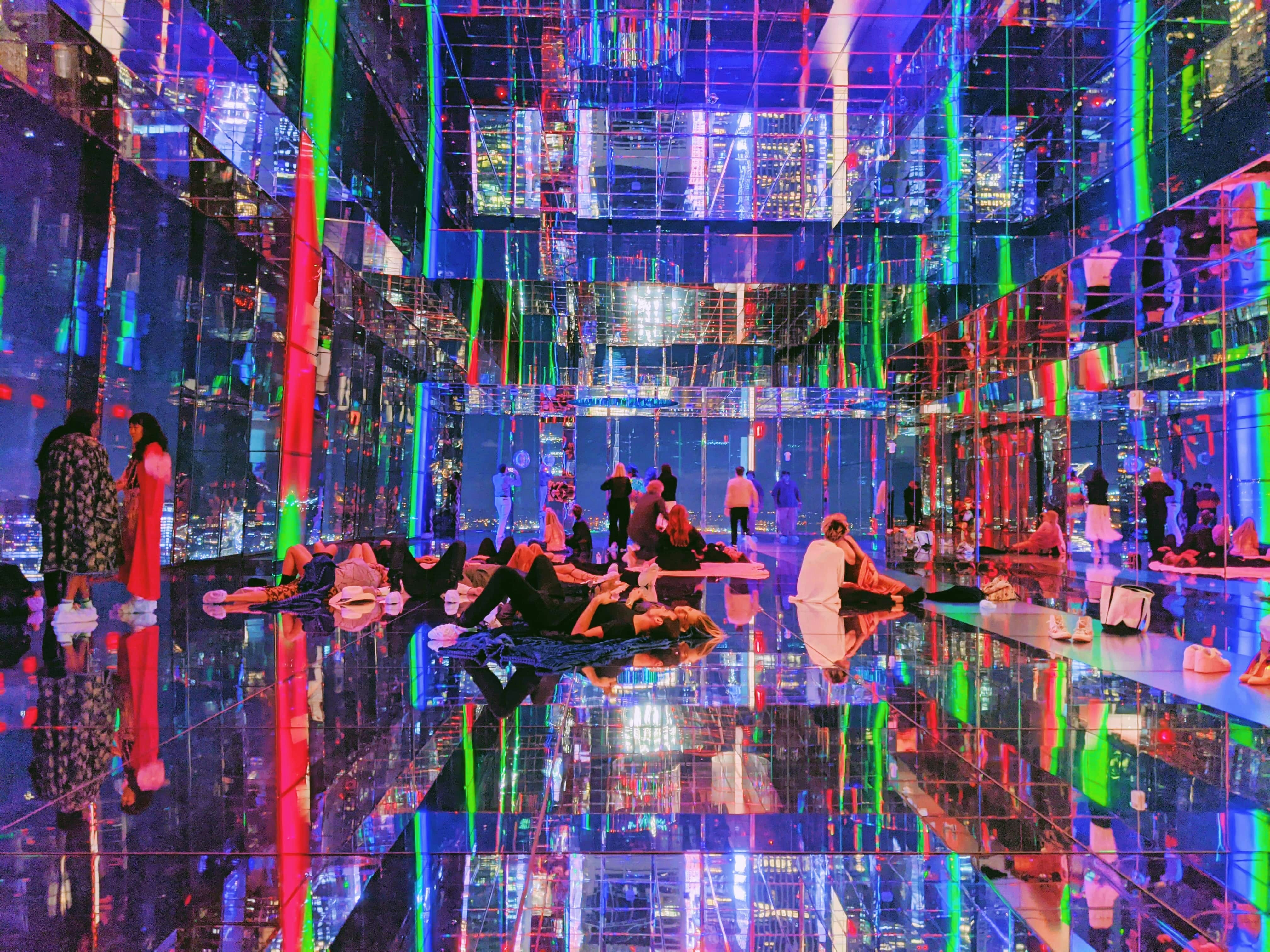 Summit One Vanderbilt observation deck at night with city skyline views.