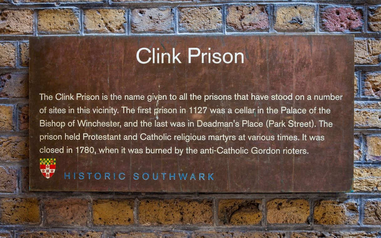 Clink Prison sign detailing its history, featured on a Harry Potter film location tour during a Thames Boat Cruise.