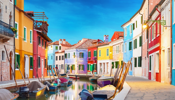 Gondolas on a canal in Venice with historic buildings in the background, Italy, September.