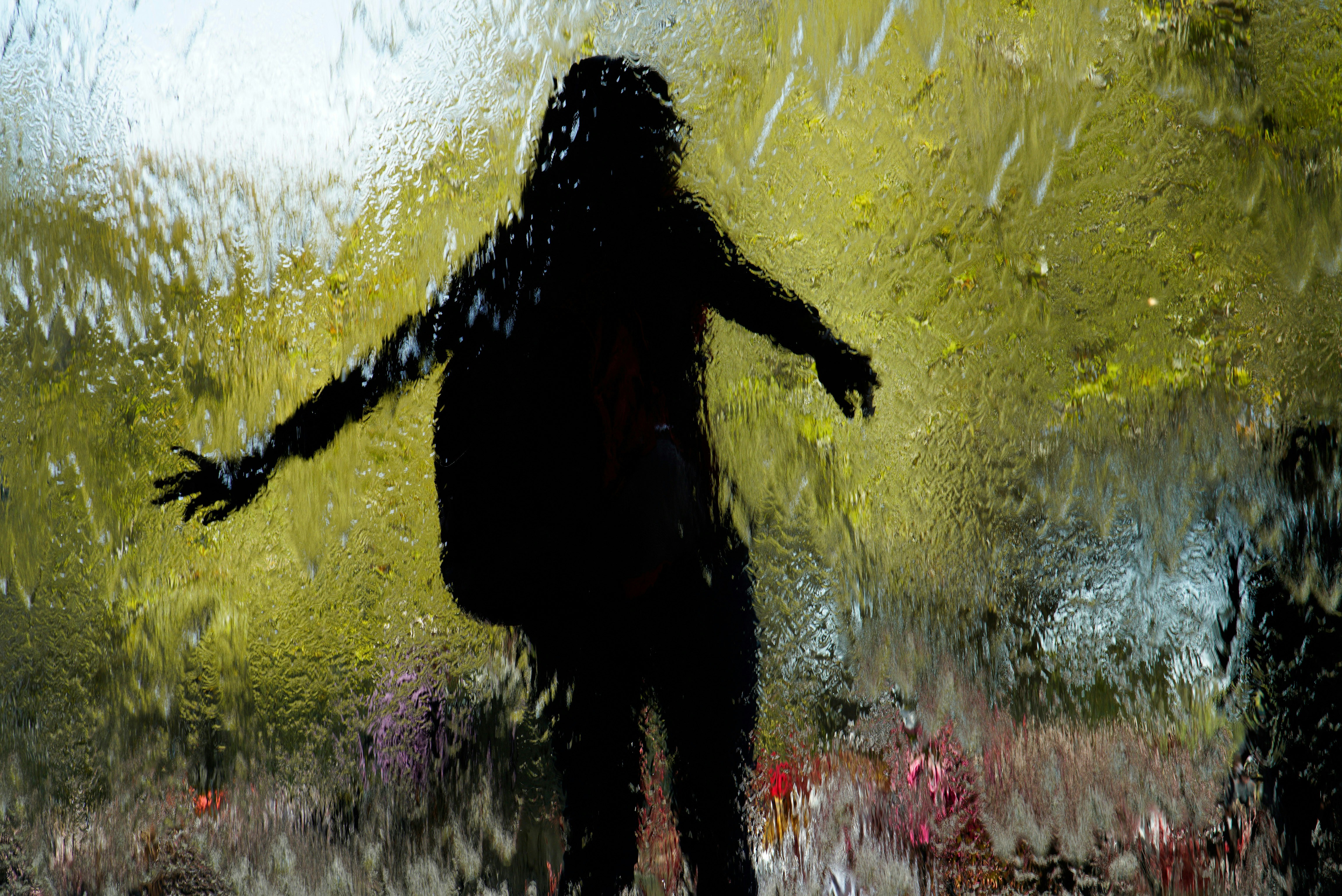 Silhouette of a person behind a water feature at Melbourne's Federation Square.