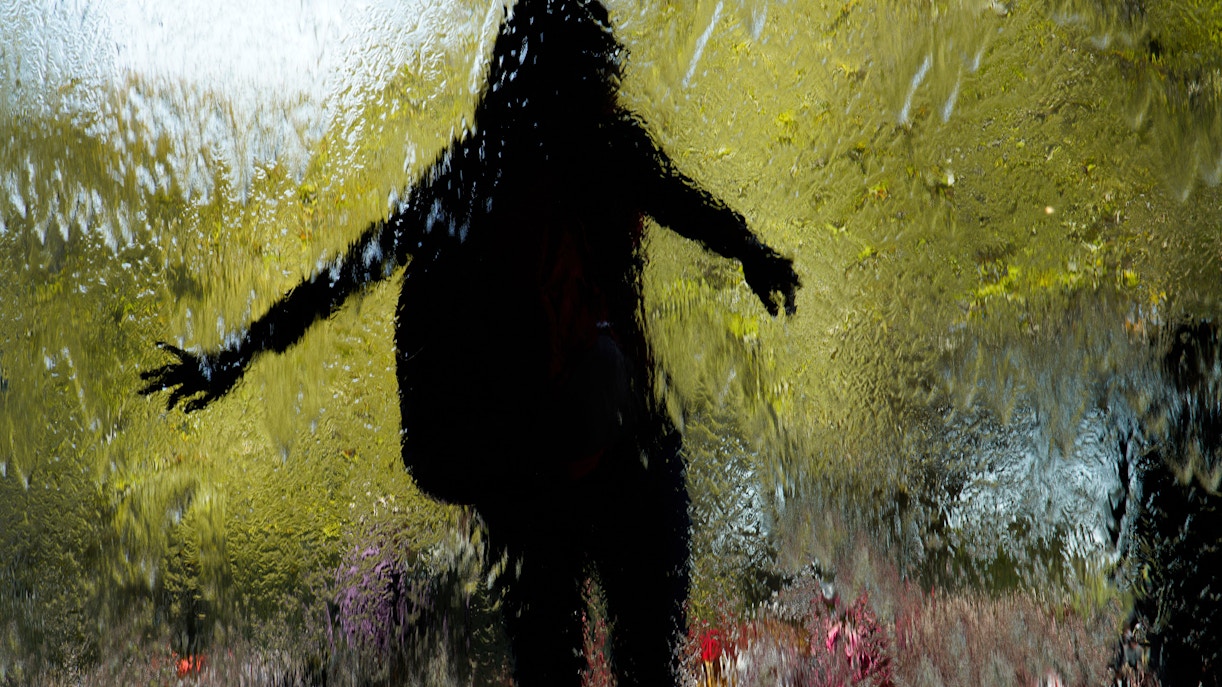 Silhouette of a person behind a water feature at Melbourne's Federation Square.