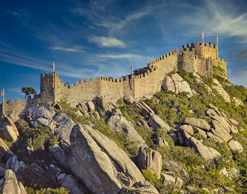 Moorish Castle walls on a rocky hilltop in Sintra, Portugal.