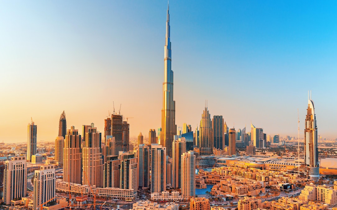 Dubai skyline with Burj Khalifa towering over modern skyscrapers.